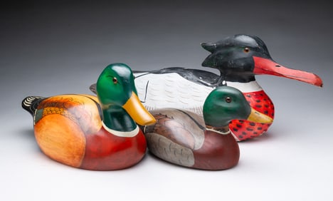 THREE AMERICAN FOLK ART CARVED AND PAINTED DUCK DECOYS.
