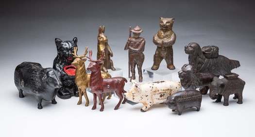 TWELVE AMERICAN CAST IRON FIGURAL STILL BANKS.