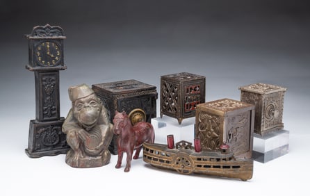 EIGHT AMERICAN CAST IRON STILL BANKS.