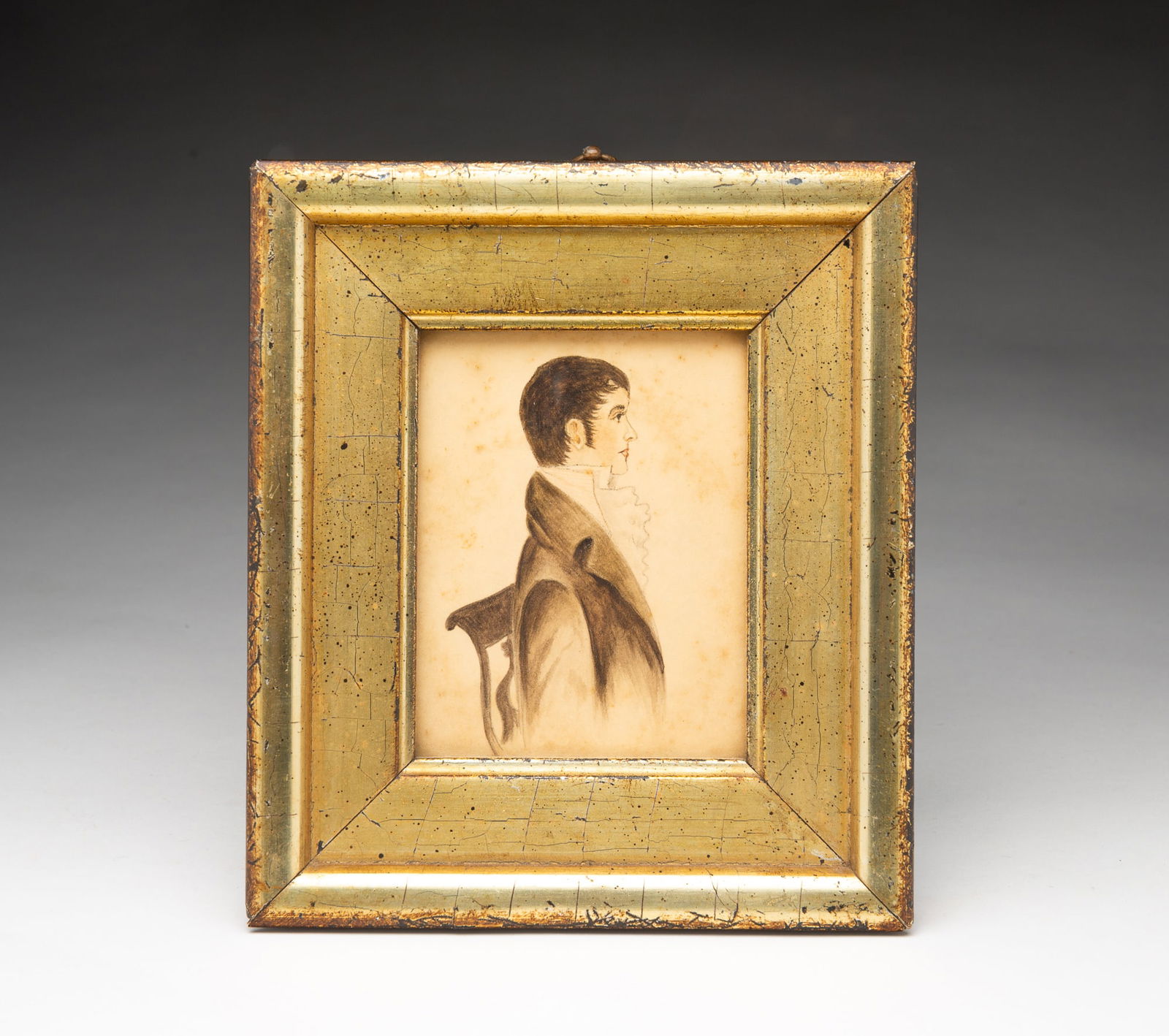 DIMINUTIVE BORGHESE WATERCOLOR PORTRAIT OF A SEATED GENTLEMAN.: Italian, Mid-20th Century. On paper. Seated man wearing a ruffled white shirt, black coat with large lapels, his brown hair swept onto his face and in a lyre back chair. 4.5"h. 3.5"w. In a gilt frame
