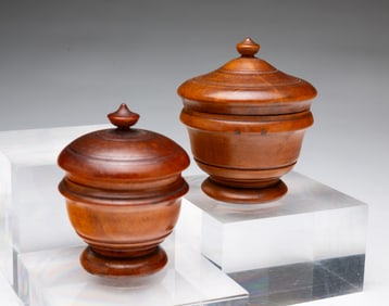 TWO DIMINUTIVE PEASEWARE LIDDED JARS.