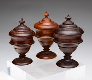 THREE GRADUATED PEASEWARE LIDDED JARS.