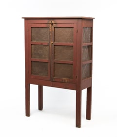 AMERICAN BURGUNDY-PAINTED PINE TWELVE-TIN PIE SAFE ON HIGH LEGS.