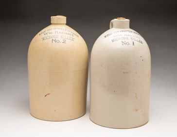 TWO WILLIAM RADAM (AUSTIN, TEXAS) GLAZED STONEWARE "MICROBE KILLER" JUGS.