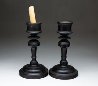 PAIR OF AMERICAN EBONIZED AND TURNED WOOD CANDLESTICKS.