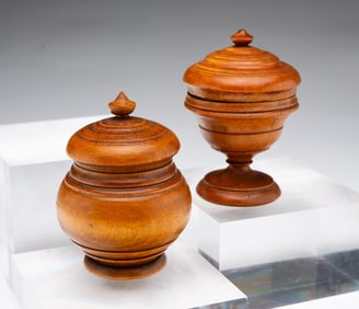 TWO DIMINUTIVE PEASEWARE LIDDED JARS.