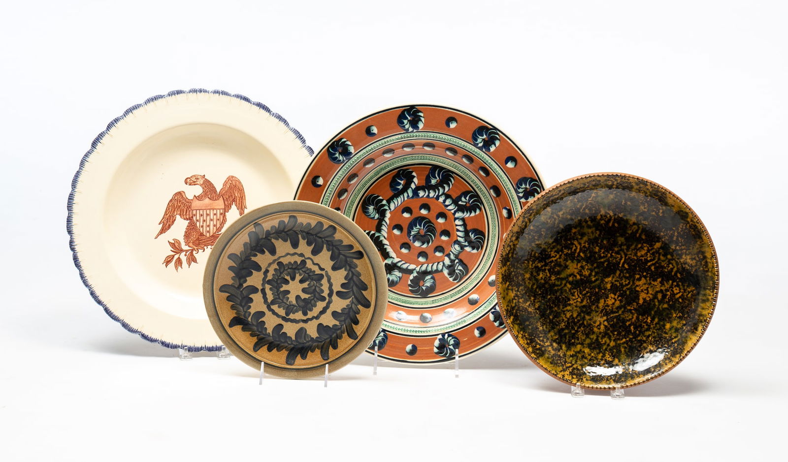 FOUR AMERICAN REPRODUCTION GLAZED POTTERY CHARGERS. (1 of 9)