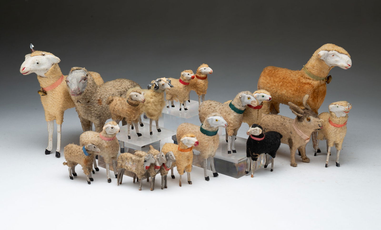 COLLECTION OF GERMAN STICK-LEG SHEEP AND RABBIT.: Ca. 1900. Stick-leg papier-mache wooly sheep and one rabbit. From 6.25"h. to 2"h.Provenance: From the Lifetime Collection of Ronald & Kathy Wright (Willoughby, Ohio). PLEASE TAKE NOTE OF OUR SHIPPING