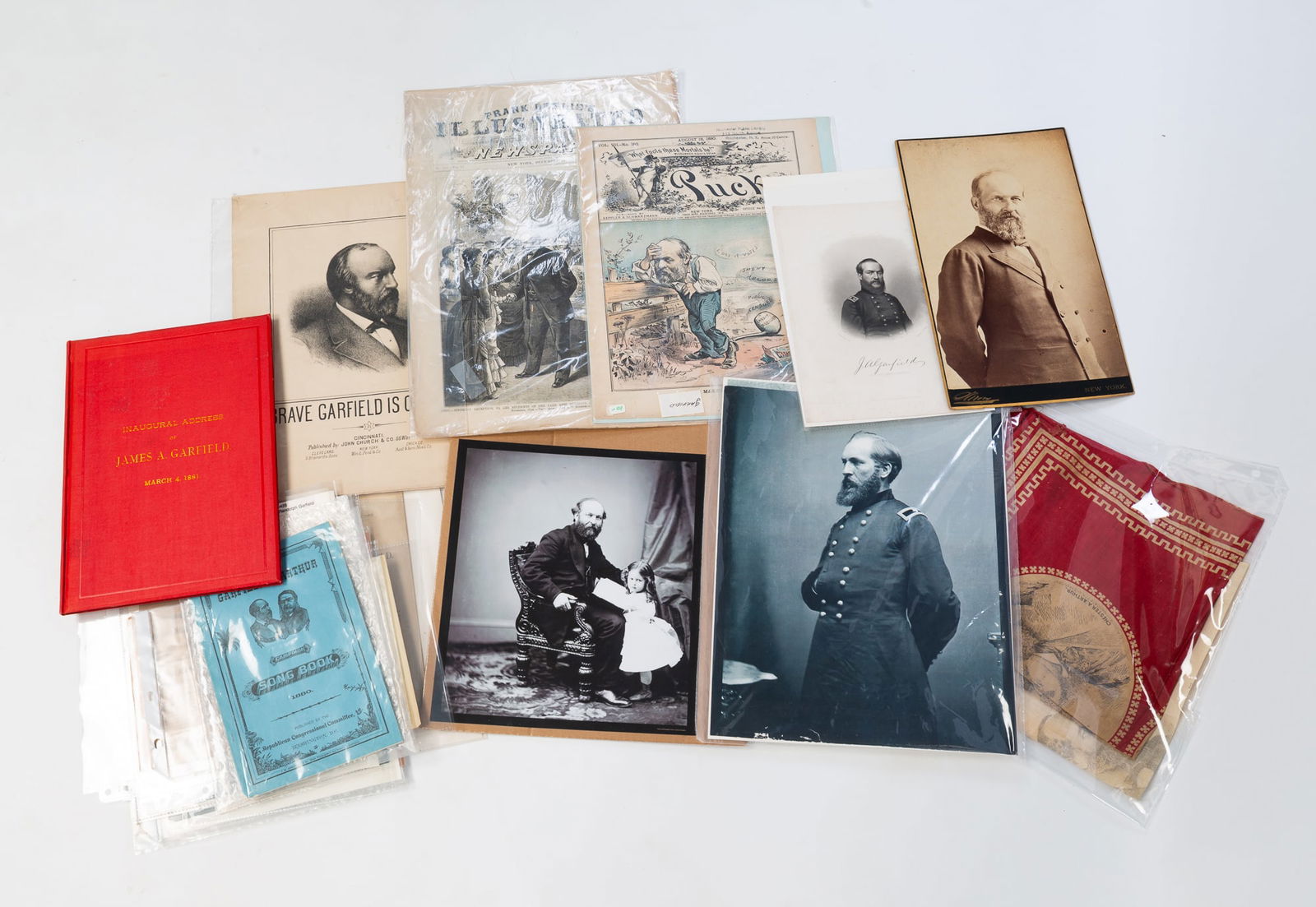 COLLECTION OF PRESIDENT GARFIELD MEMORABILIA.: Late 19th Century. Large cabinet card portrait, photo reprints, campaign bandannas, bound copyof his inaugural address, sheet music, cartoons, periodicals and more.