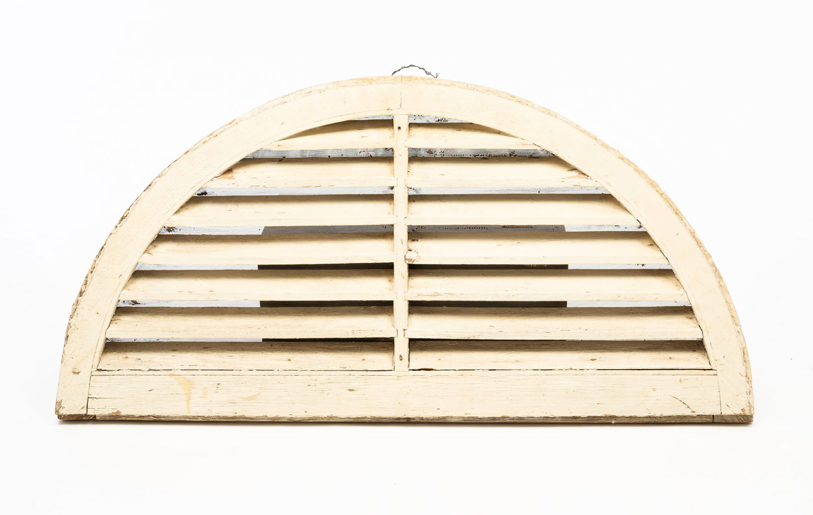 AMERICAN WHITE-PAINTED PINE HALF-ROUND GABLE VENT.: Mid-19th Century. Laminated frame with louvers and layered white paint. 19.25"h. 39.75"w. 1.5"d.Provenance: From the Lifetime Collection of Ronald & Kathy Wright (Willoughby, Ohio).