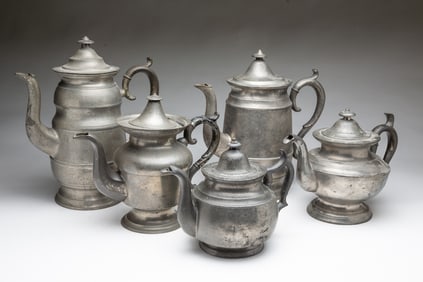 FIVE AMERICAN PEWTER FOOTED COFFEE AND TEAPOTS, INCL. SELLEW & CO. (CINCINNATI, OHIO).