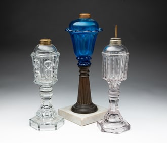 THREE AMERICAN GLASS FLUID LAMPS.