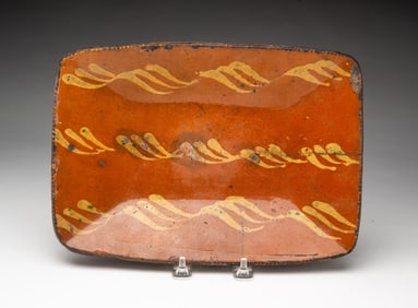 AMERICAN SLIP-DECORATED REDWARE LOAF PAN.