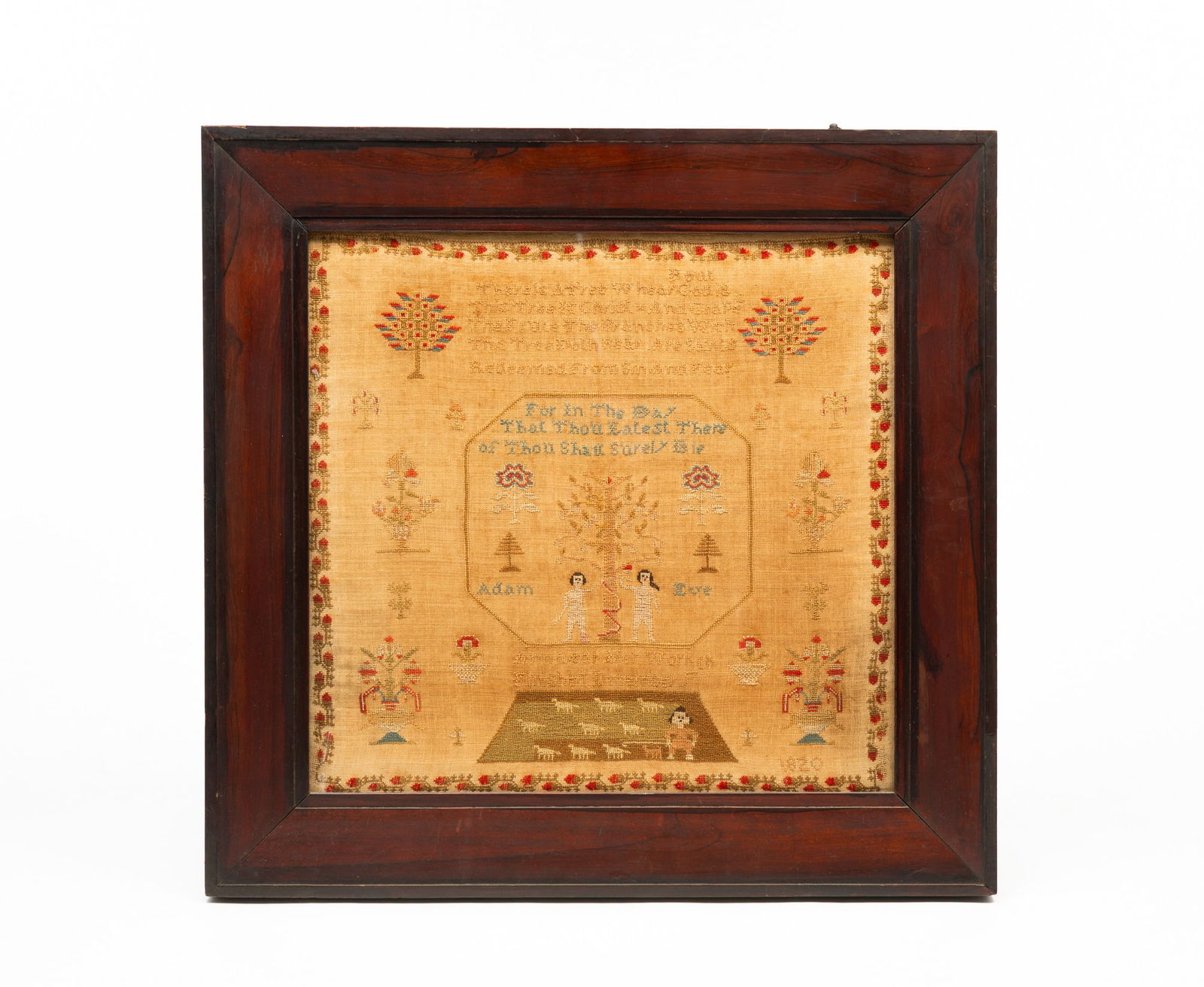 AMERICAN ADAM AND EVE NEEDLEWORK SAMPLER, DATED 1820.: First quarter 19th Century. Linen. Petit point, strawberry border, trees, urns of flowers, sheep, religious verse and at bottom "Anne _ _ _ _ Her Work Finished December 4th, 1820". In a period rosewoo