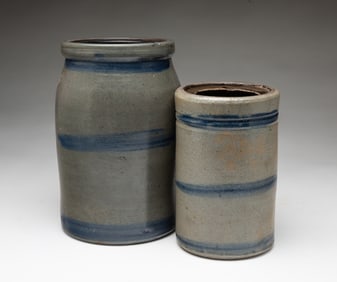TWO AMERICAN STONEWARE CANNING JARS WITH COBALT STRIPES.