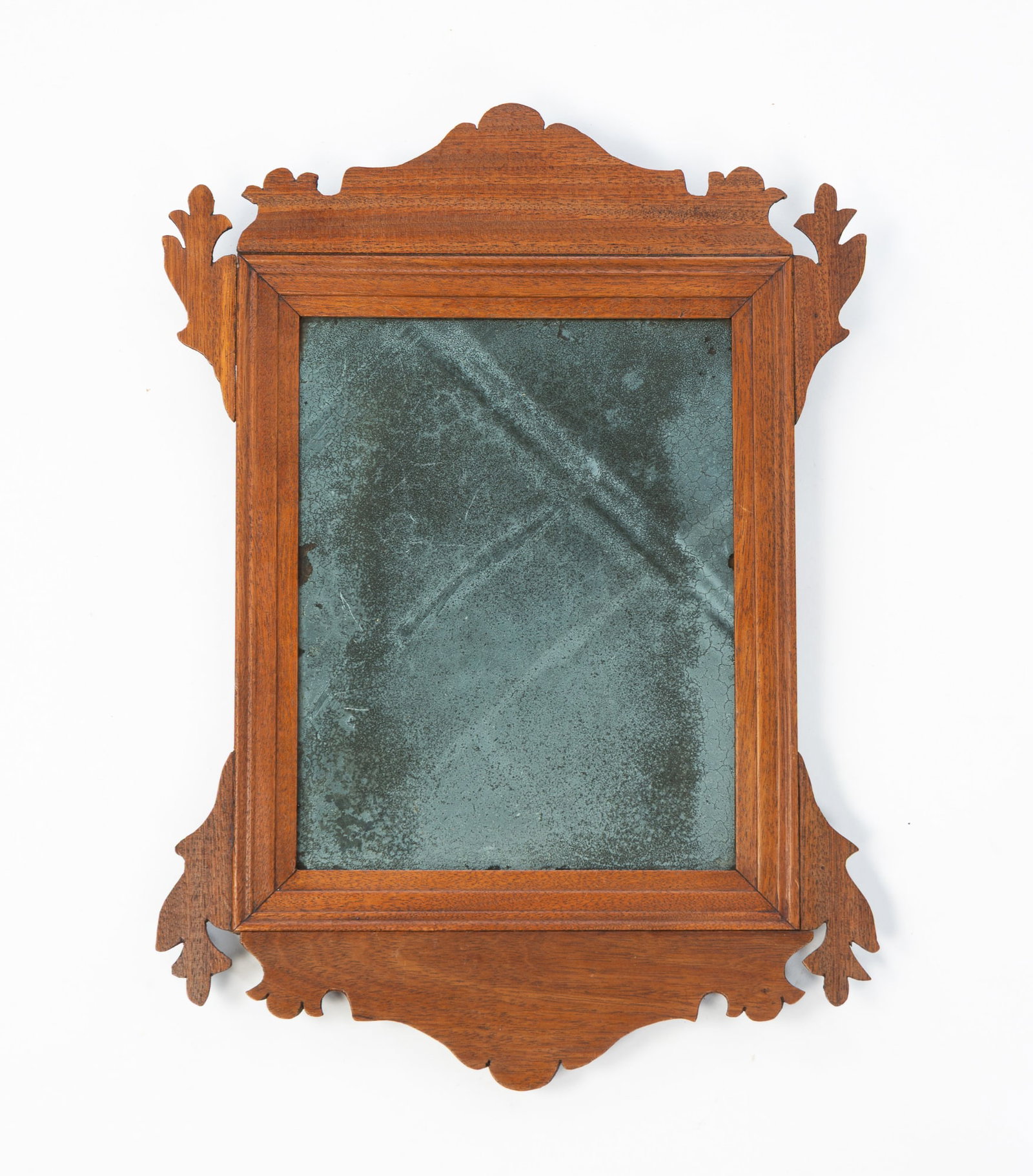 DIMINUTIVE AMERICAN CHIPPENDALE STYLE MAHOGANY MIRROR.: 19th Century. Carved crest and bottom, molded frame, and old glass. 15.25"h. 11"w.Provenance: From the Lifetime Collection of the late Deb Fisher (Lebanon, Ohio).