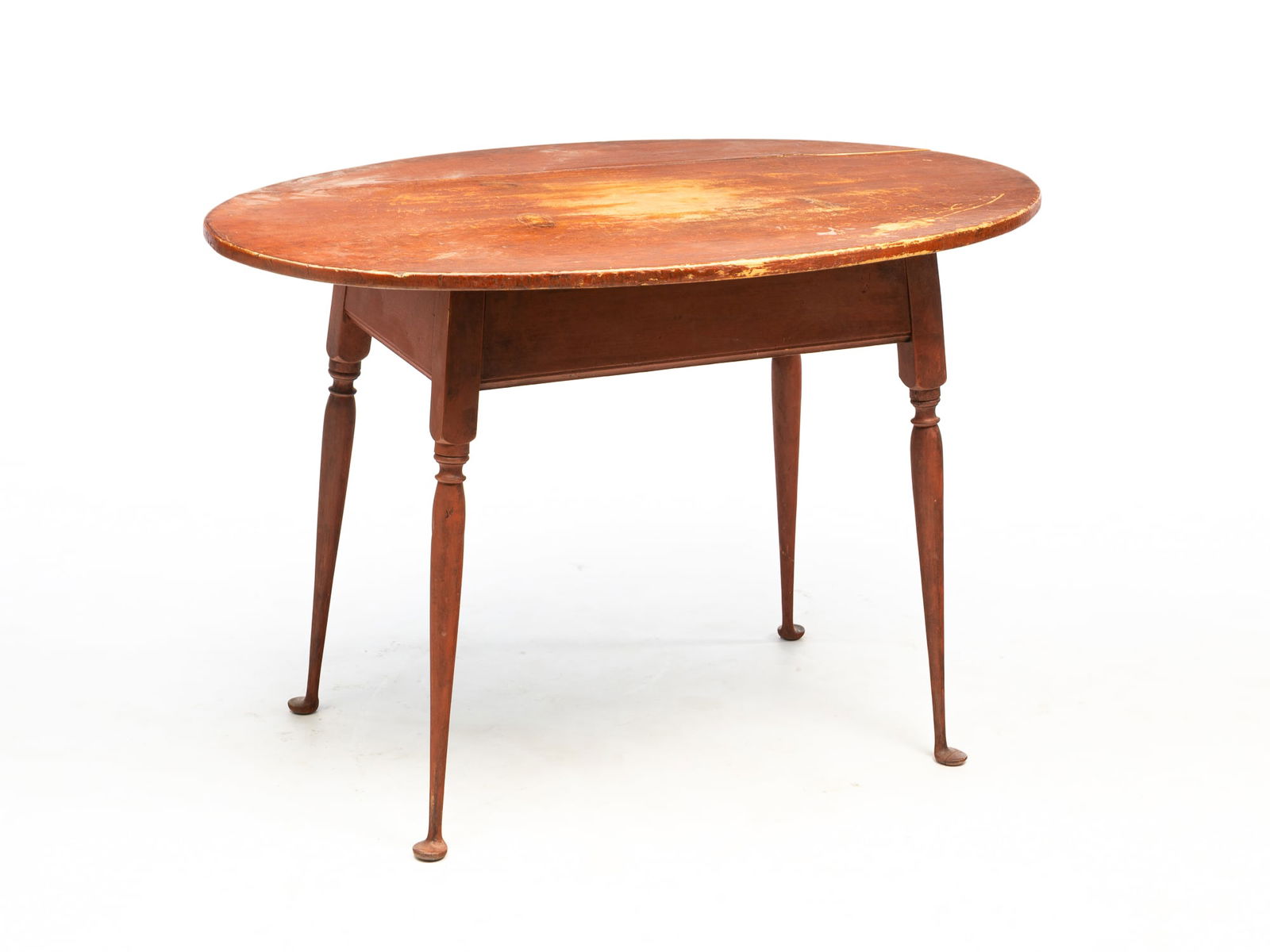 AMERICAN QUEEN ANNE RED-PAINTED PINE AND MAPLE TAVERN TABLE.: 18th Century. Having an oval, overhanging top above a straight apron with beaded lower edges and rising on turned and splayed legs ending in pad feet. 28"h. 28.75"w. 42.25"d.Provenance: From the Lifet
