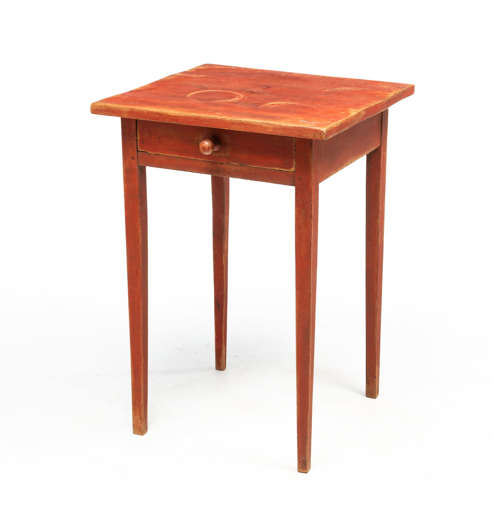 AMERICAN HEPPLEWHITE RED-WASHED CHERRY STAND.: 19th Century. Poplar secondary. Having a rectangular, overhanging top above a dovetailed frieze drawer and rising on square, tapered legs. 27"h. 19"w. 18.75"d.Provenance: From the Lifetime Collection