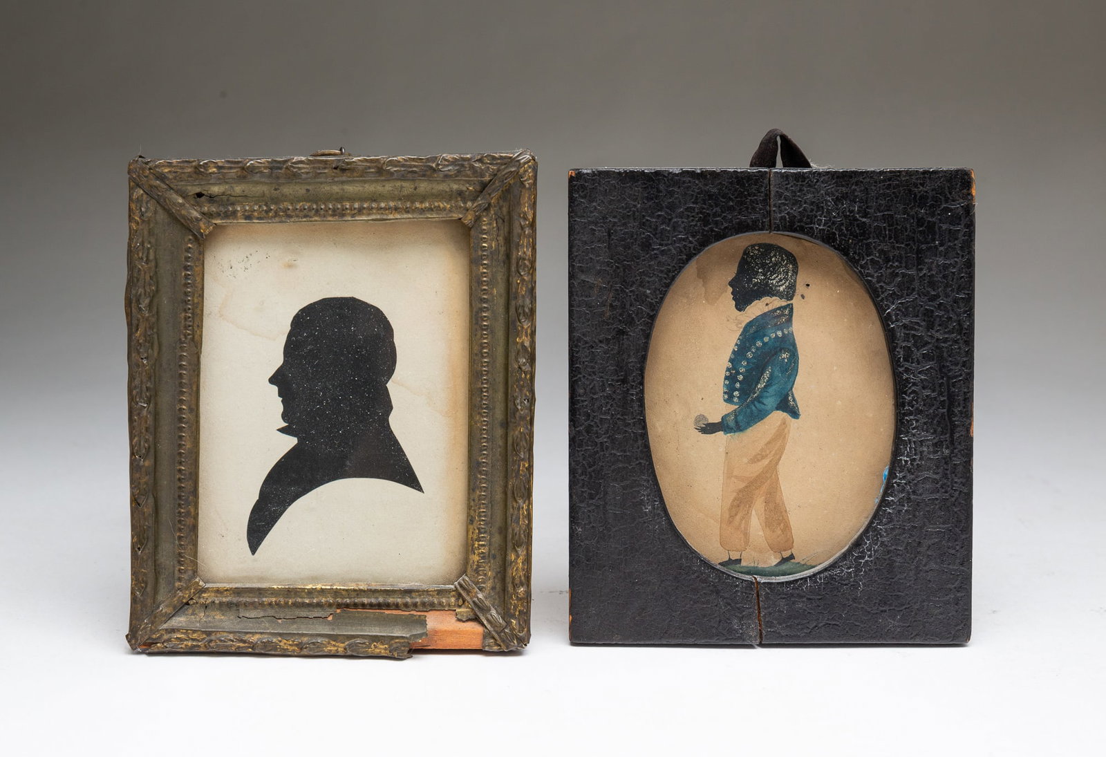 TWO AMERICAN SCHOOL SILHOUETTE PORTRAITS OF GENTLEMEN.: 19th Century. Watercolor and gouache full-length portrait of man facing left, having white hair, a ruffled collar, a blue jacket with white embellishments, and tan pants, in a black-lacquered frame.