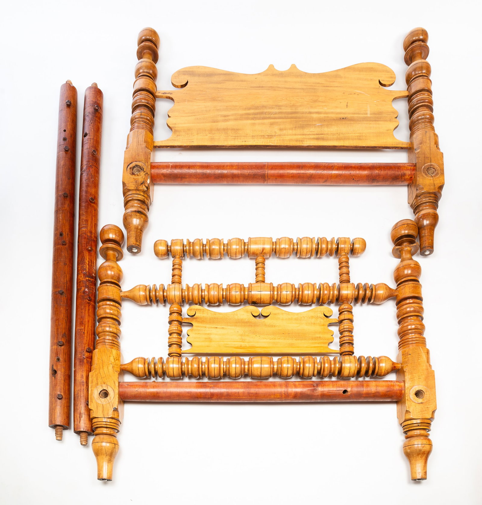 AMERICAN EMPIRE MAPLE ROPE BED.: 19th Century. Turned posts with ball finials, headboard and footboard with intricate turnings and panels. 48.75"h. 54"w. approximately 90"l.Provenance: From the Lifetime Collection of the late Deb