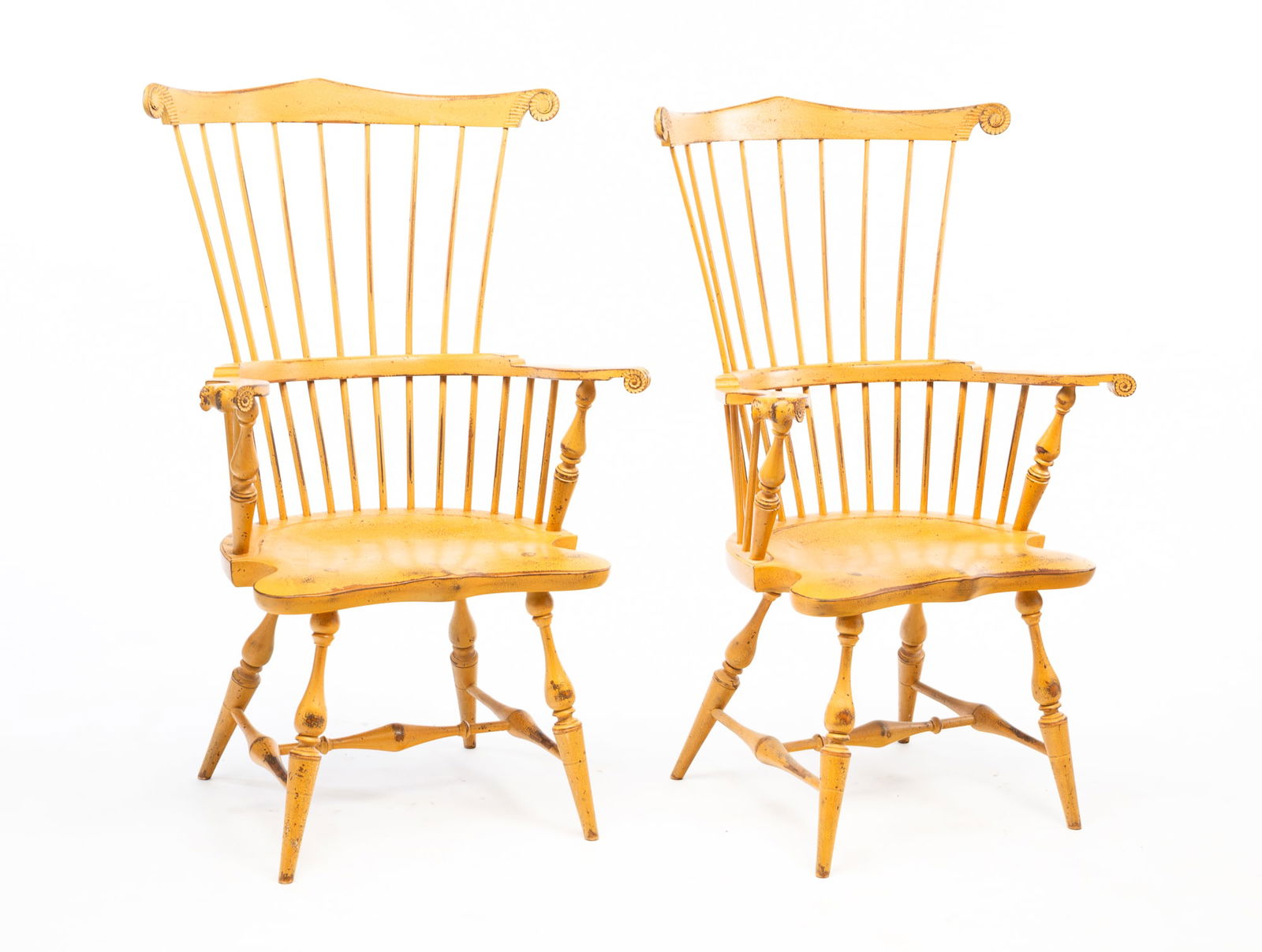 PAIR OF RIVER BEND CHAIR CO. (LEBANON, OHIO) COLONIAL STYLE YELLOW-PAINTED FAN-BACK WINDSOR: Late 20th-early 21st Century. Mixed woods. Each having a scrolled crest rail above a rod back continuing to knuckle arms and a saddle seat. Rising on turned and splayed legs joined by an H-stretcher.