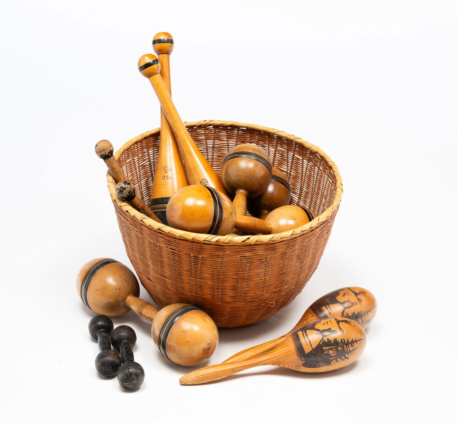 COLLECTION OF TURNED WOOD JUGGLING PINS AND DUMBBELLS PLUS BASKET. (1 of 5)