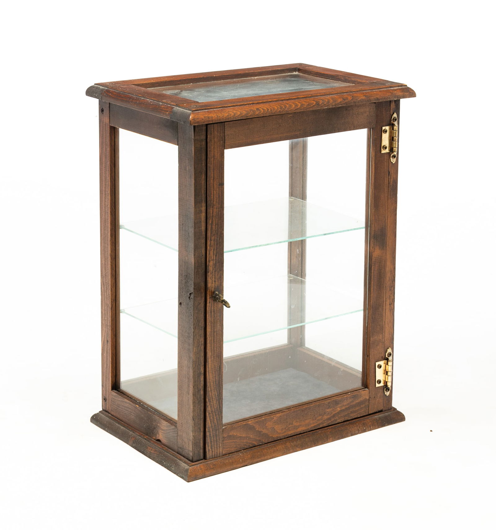 AMERICAN PINE TABLETOP DISPLAY CASE.: Late 20th Century. Having a rectangular, glass paneled top above three glass-paneled sides and one door. The interior with two removable glass shelves. 20.25"h. 15.5"w. 10.5"d.Provenance: From the Lif