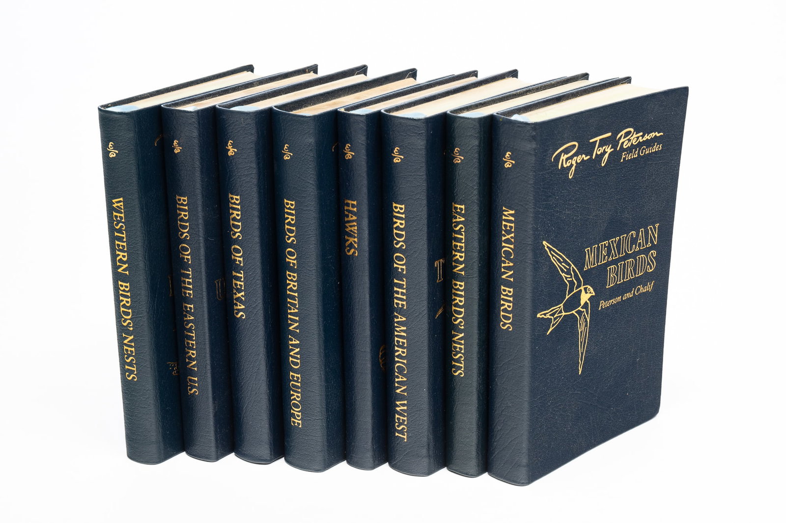 ROGER TORY PETERSON (AMERICAN, 1908-1996) COLLECTION OF EIGHT 50TH ANNIVERSARY BIRD FIELD GUIDE: 20th Century. Eight Collector's Lifetime Edition field guide books, published by the Easton Press (Norwalk, Connecticut) in 1984-87, bound in dark blue leather covers with light blue ribbon bookmarks