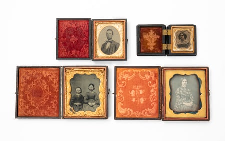 A DAGUERREOTYPE AND THREE AMBROTYPES IN GUTTA PERCHA CASES.