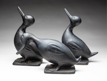 THREE AMERICAN PAINTED AND CAST IRON DUCK DOORSTOPS.