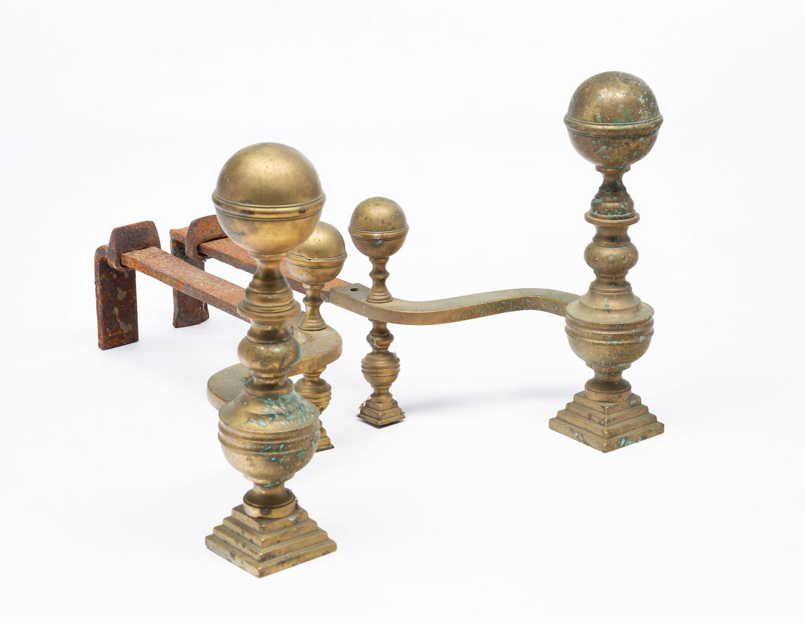 PAIR OF BRASS AND WROUGHT IRON CANONBALL ANDIRONS.: Early 19th Century. Seamed construction, stepped plinths, and wrought iron backs. 16"h. 10"w. 24"d.Provenance: From the collection of Mark and Sandy Keily.