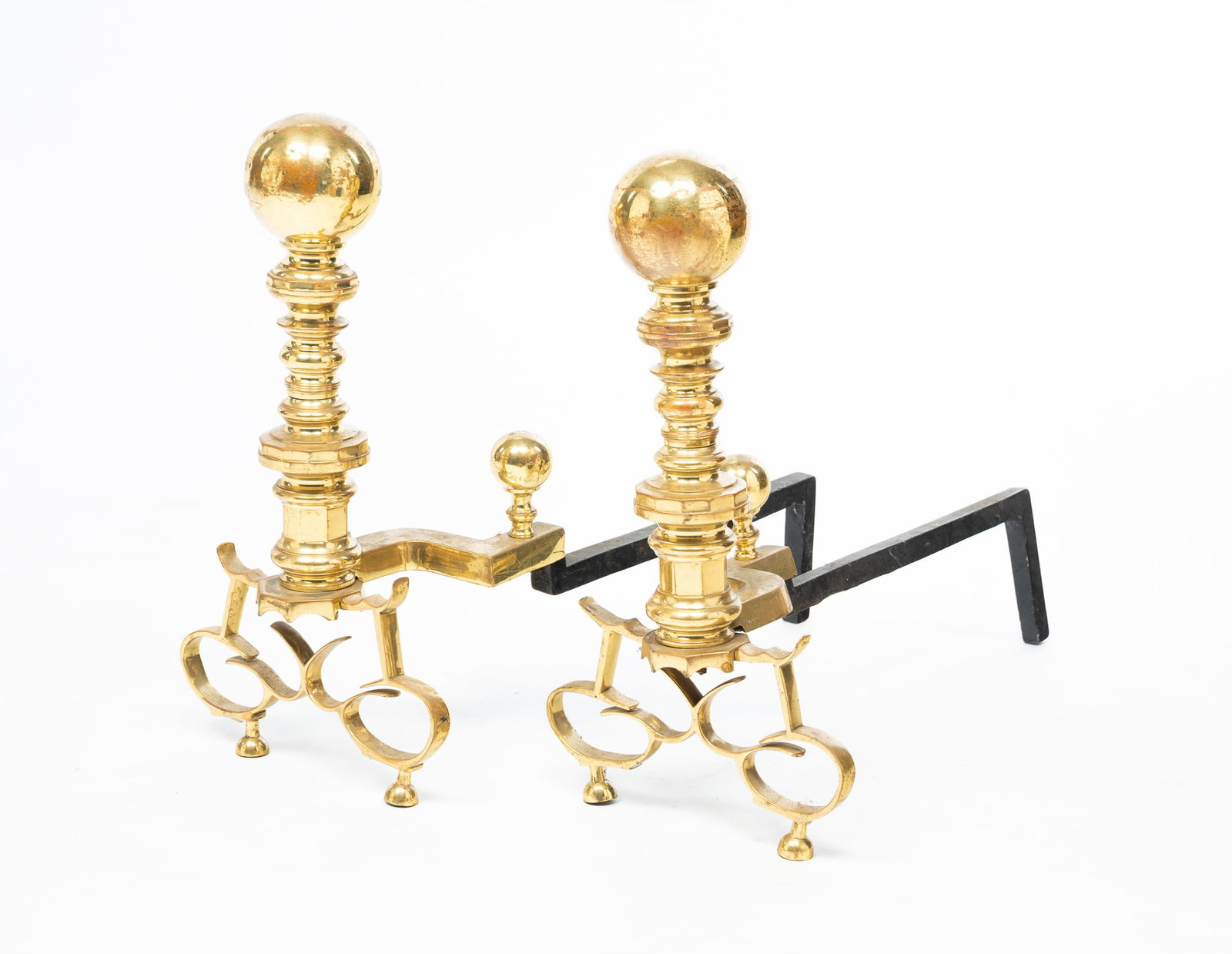 PAIR OF AMERICAN BRASS AND IRON CANNONBALL ANDIRONS.: Late 20th Century. Brass and cast iron. Spherical finials, scrolled legs, and half-sphere finial. 18"h. 9.5"w. 23"d.