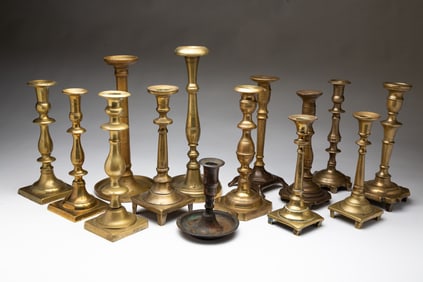 COLLECTION OF EASTERN EUROPEAN CAST BRASS CANDLESTICKS.