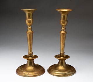 PAIR OF EASTERN EUROPEAN CAST BRASS CANDLESTICKS.