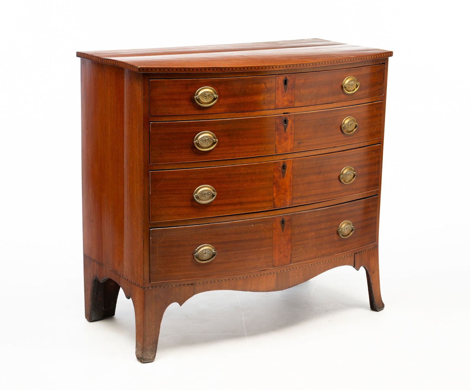 AMERICAN HEPPLEWHITE MAHOGANY AND LINE-INLAID FOUR-DRAWER BOWFRONT CHEST.: Ca. 1800. Pine secondary. Having a rectangular top with bowed front edge above a conforming case and stack of four long drawers. It rises on splayed, French feet. 37.5"h. 39.25"w. 21"d.