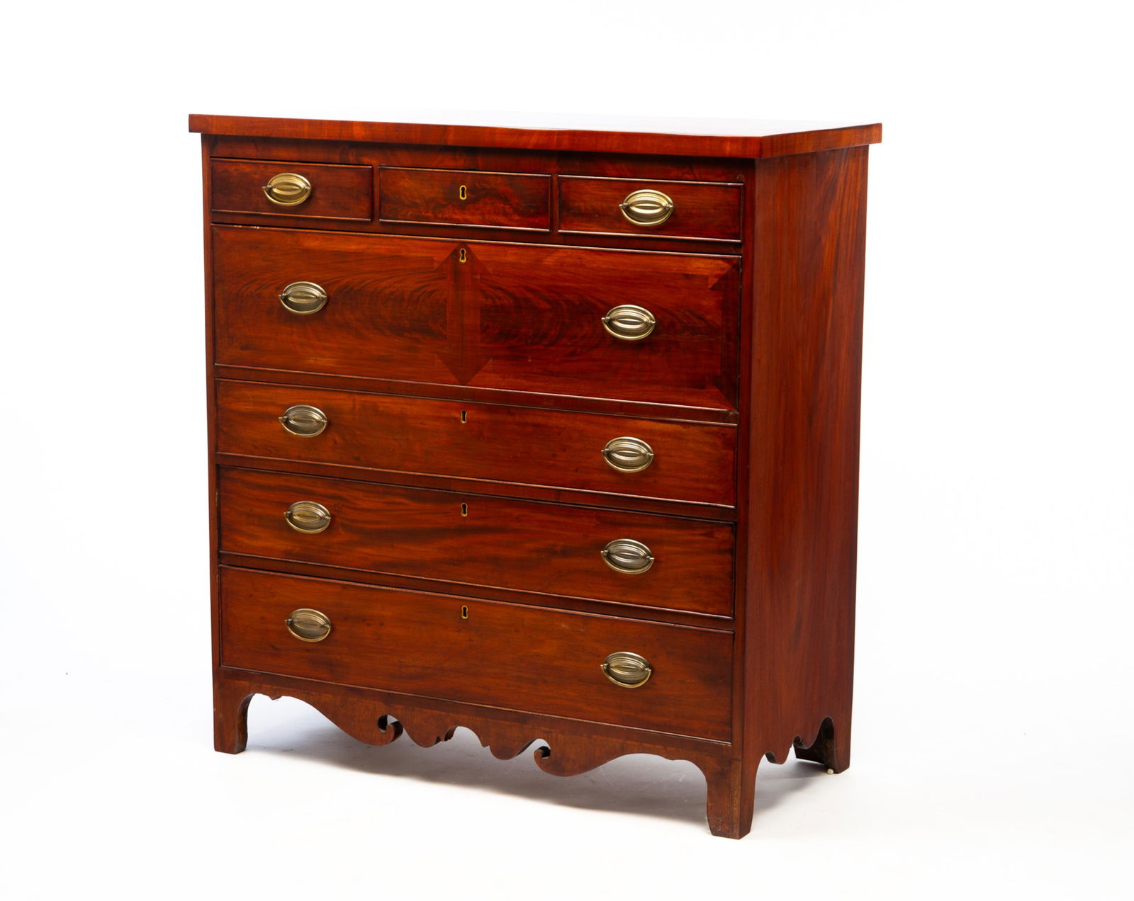 AMERICAN HEPPLEWHITE MAHOGANY SEVEN-DRAWER CHEST.: First quarter 19th Century. Mahogany veneer with pine secondary. Solid ends, three-over-four dovetailed drawers with applied beaded edges, scrolled aprons and straight legs. Top wide drawer and base w