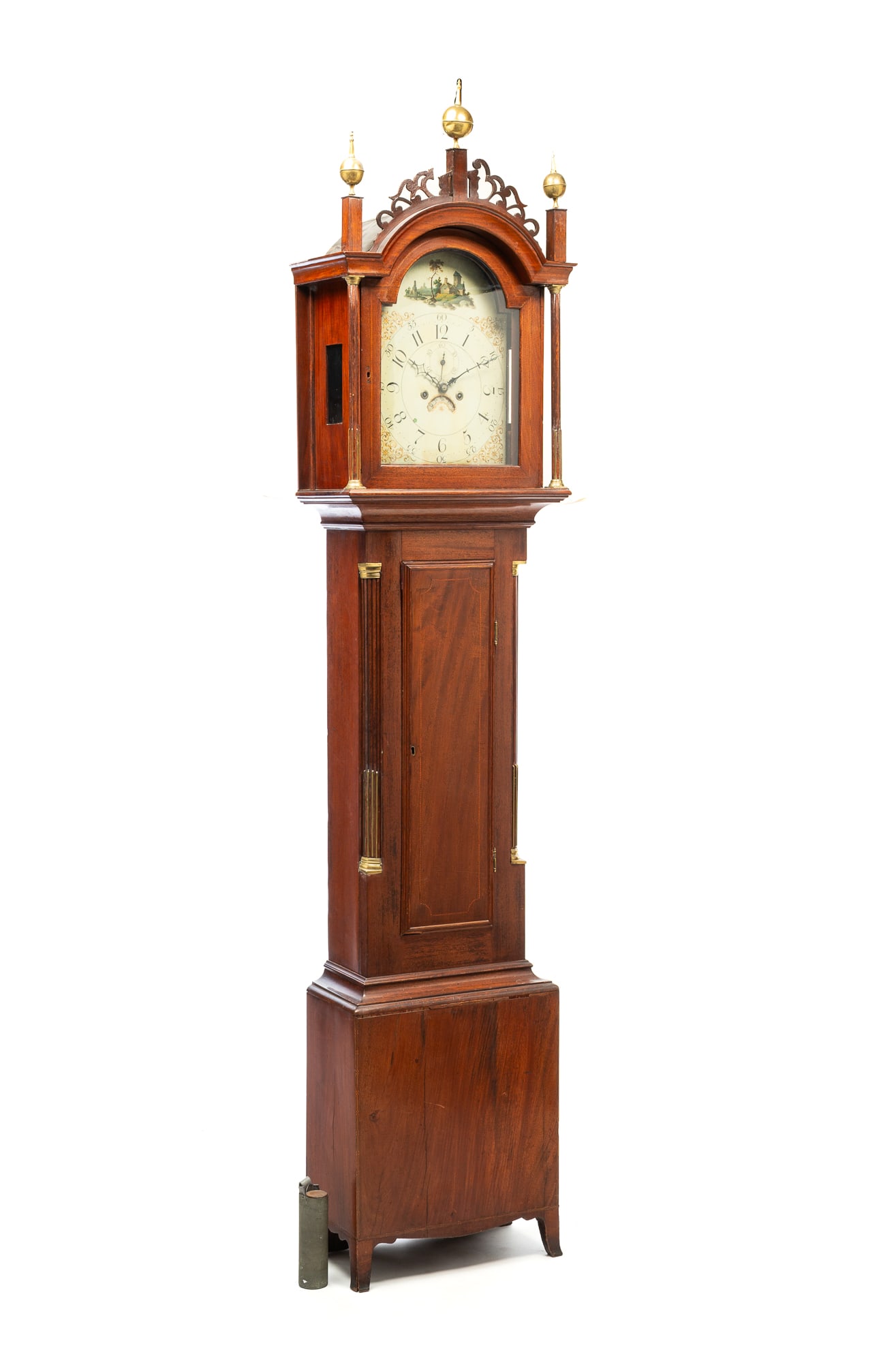 GEORGE III MAHOGANY TALL CASE CLOCK.: English, ca. 1800. Bonnet with arched top, spherical brass finials, jigsaw cut out fretwork, fluted pilasters with brass capitals and plinths, brass wire stopped fluting, and arched glass door. Case w