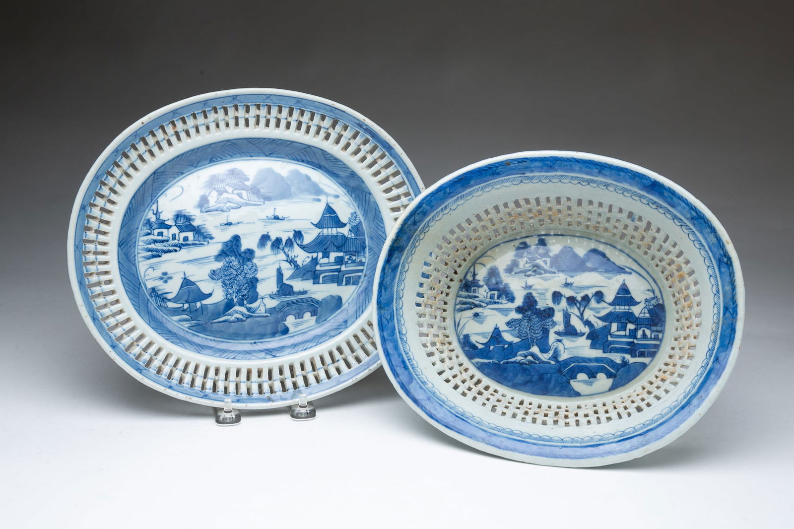 CHINESE CANTON CHESTNUT BOWL AND UNDERPLATE.: Mid-19th Century. Porcelain. Reticulated bowl and underplate with typical scene and border. Bowl 4"h. 10.5"w. and underplate 11"w. 9.5"I.Provenance: From The Lifetime Collection of Janet & Charles