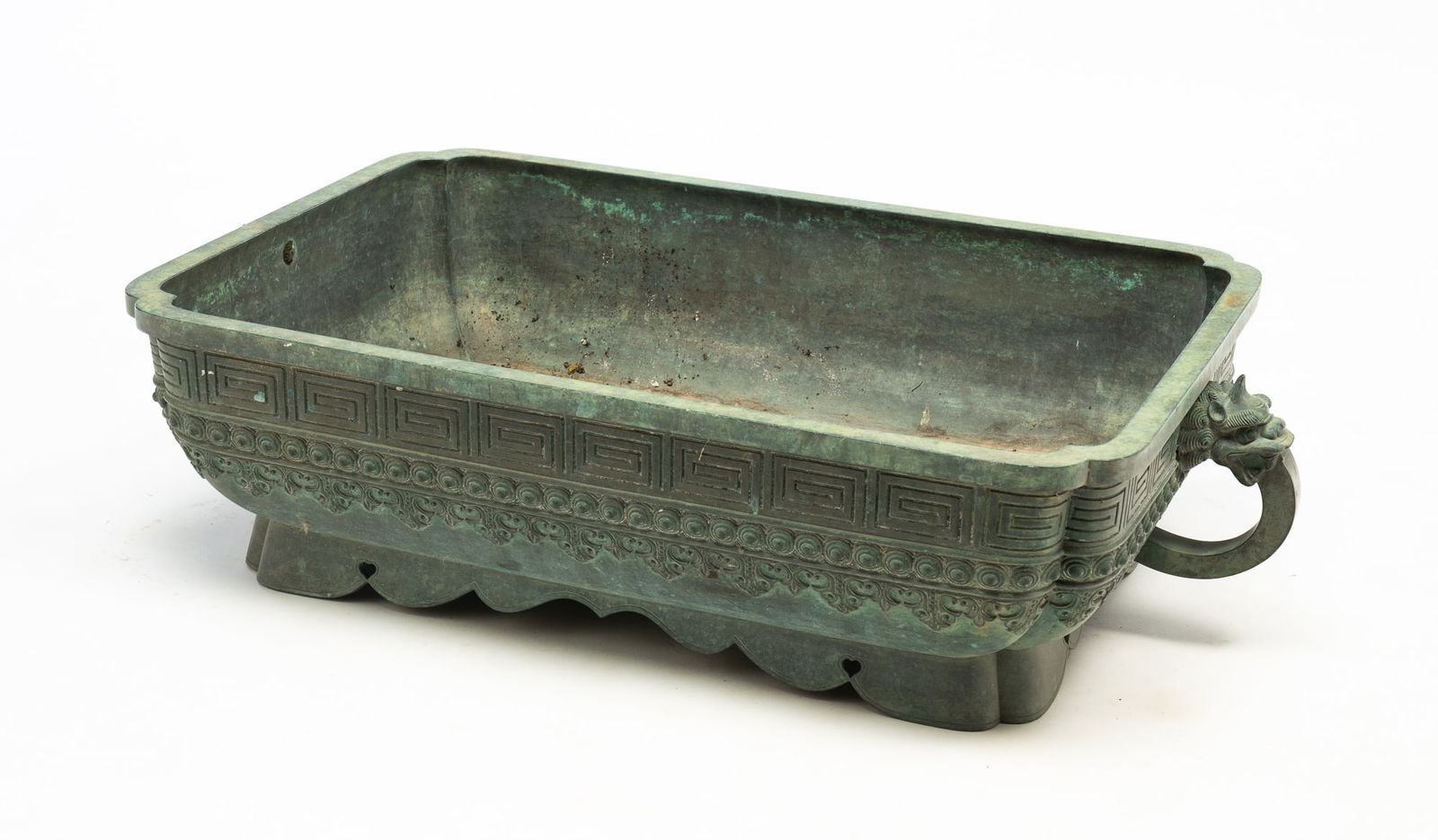 CHINESE BRONZE DOUBLE-HANDLED PLANTER.: Early-mid 20th Century. Rectangular planter with rounded corners, fluted sides, foo dog handled and scalloped bottom apron. Holes to bottom for draining. 8"h. 32"w. 19"d.