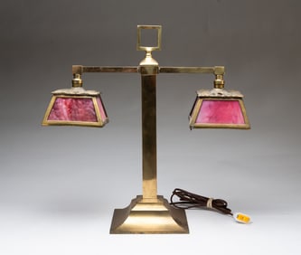 AMERICAN BRASS TWO-LIGHT DESK LAMP WITH PINK SLAG GLASS SHADES.