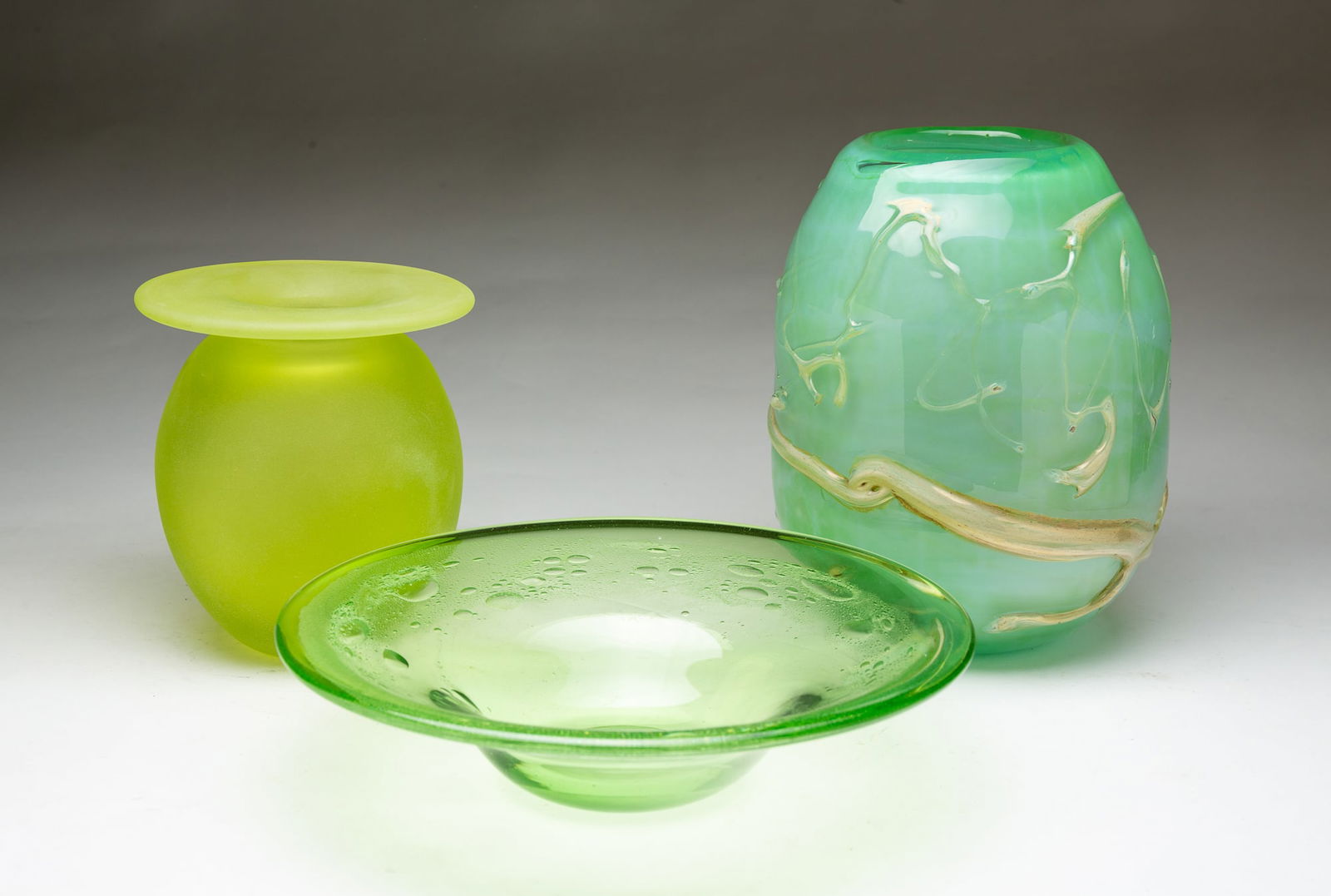 TWO GREEN ART GLASS VASES AND A BOWL. (1 of 6)