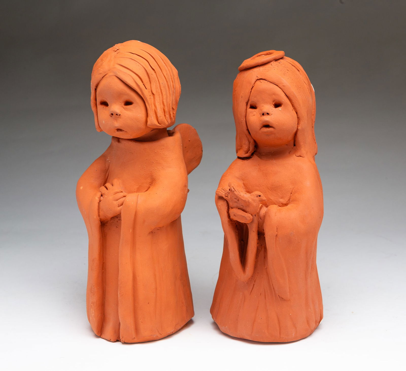 TWO ANN ENTIS (AMERICAN, 1927-2007) TERRACOTTA ANGELS. (1 of 6)