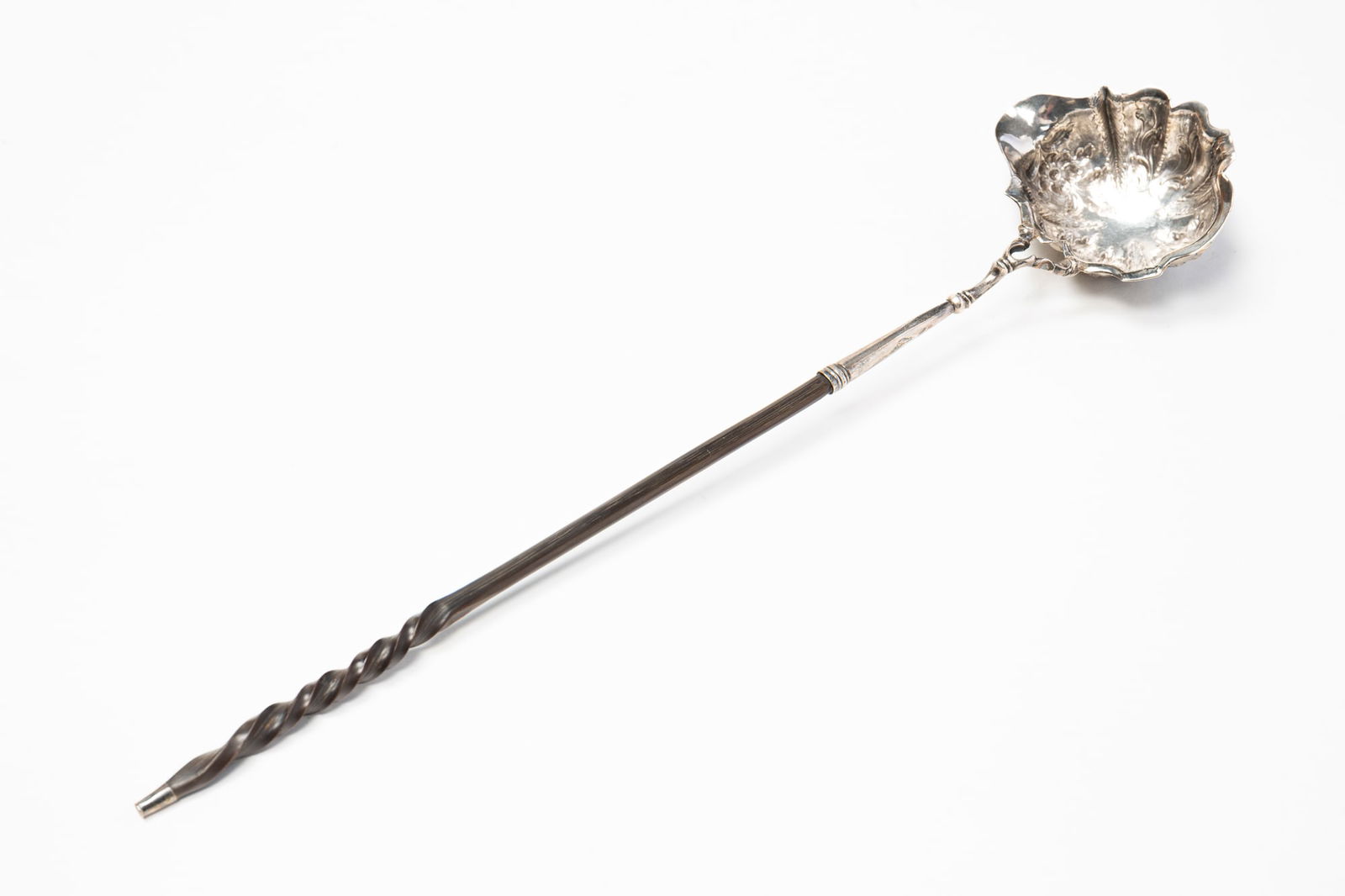 BENJAMIN BREWOOD II (LONDON) STERLING SILVER LADLE.: England, Second half 18th Century. Beautifully floral chased bowl with spout, horn handle, indistinct date mark and engraved "F.S.H." on bottom of bowl. 14.75"l. Approximately 1.6 ozt with handle.