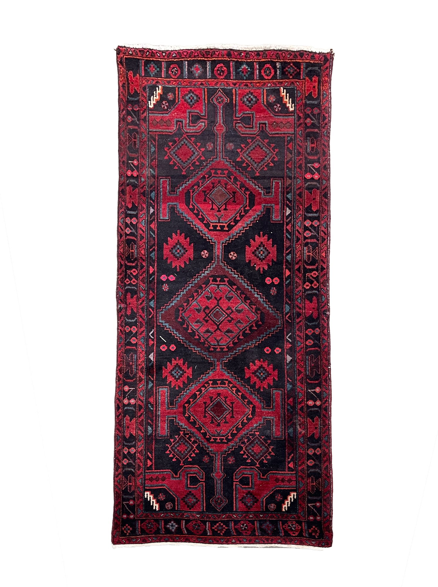 ORIENTAL WOOL RUNNER.: 20th Century. Hand-knotted. Triple-medallion center, black field, red and black borders and multi-colored overall geometric pattern. 3' 9"w. 8' 7"l.Provenance: From the Lifetime Collection of the late