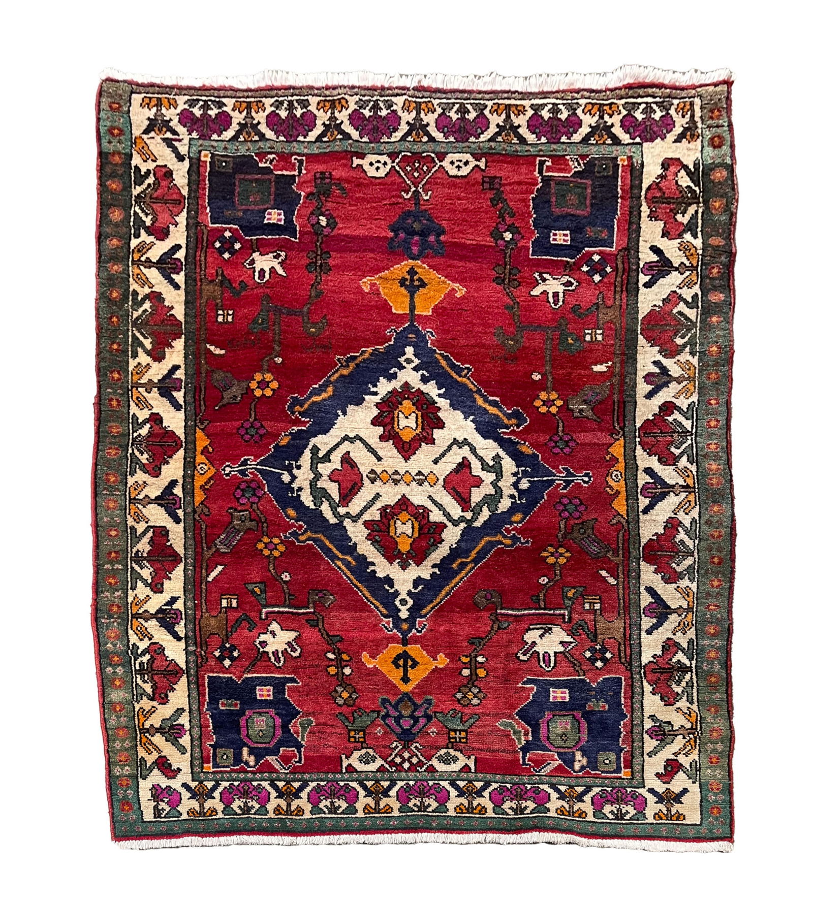ORIENTAL WOOL AREA RUG.: 20th Century. Hand-knotted. Red field, diamond shaped medallion, cream borders and overall multicolored floral and geometric pattern. 5' 7.5"w. 7' 2"l.Provenance: From the Lifetime Collection of the
