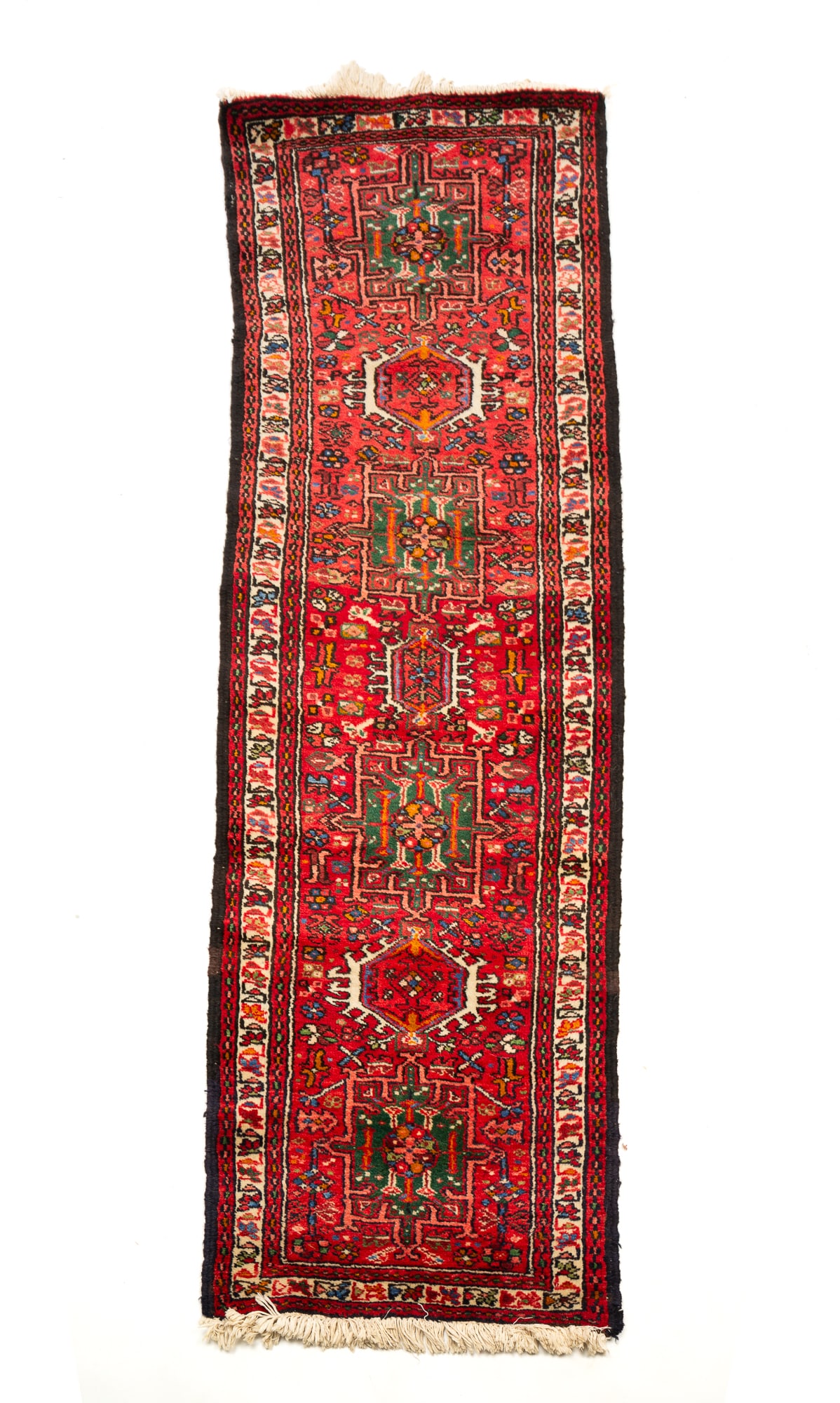 PERSIAN CAUCASIAN RUNNER.: Second half 20th Century. Wool. Seven medallions on a red field with dark red and cream borders and multi-colored geometric and floral pattern. 1'11"w. 6'5"l.