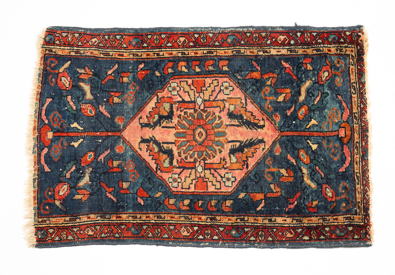 ORIENTAL WOOL SCATTER RUG.: Mid-20th Century. Blue field, salmon medallion, tan and rust borders with overall floral and geometric pattern. 2'w. 2'10"l.