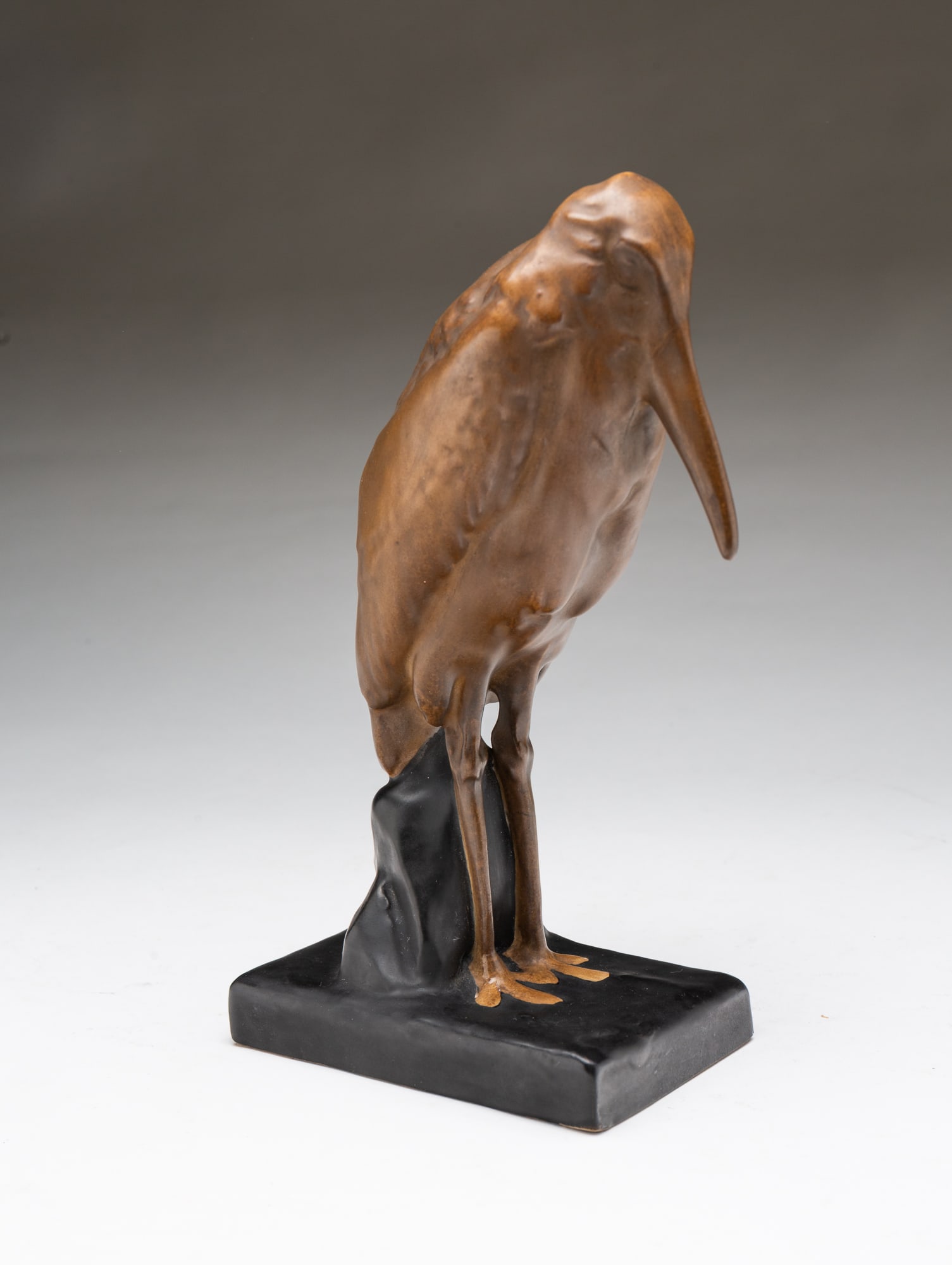 EDUARD STELLMACHER (GERMAN, 1868-1932) FOR TURN-TEPLITZ AMPHORA (CZECH REPUBLIC) ART NOUVEAU GLAZED: Ca. 1900. Standing stork figure glazed in brown and black, having a Stellmacher Teplitz factory mark and impressed with "545" model number on underside. 9.5"h. 3.25"w. 6"d.Provenance: From the Lifetim