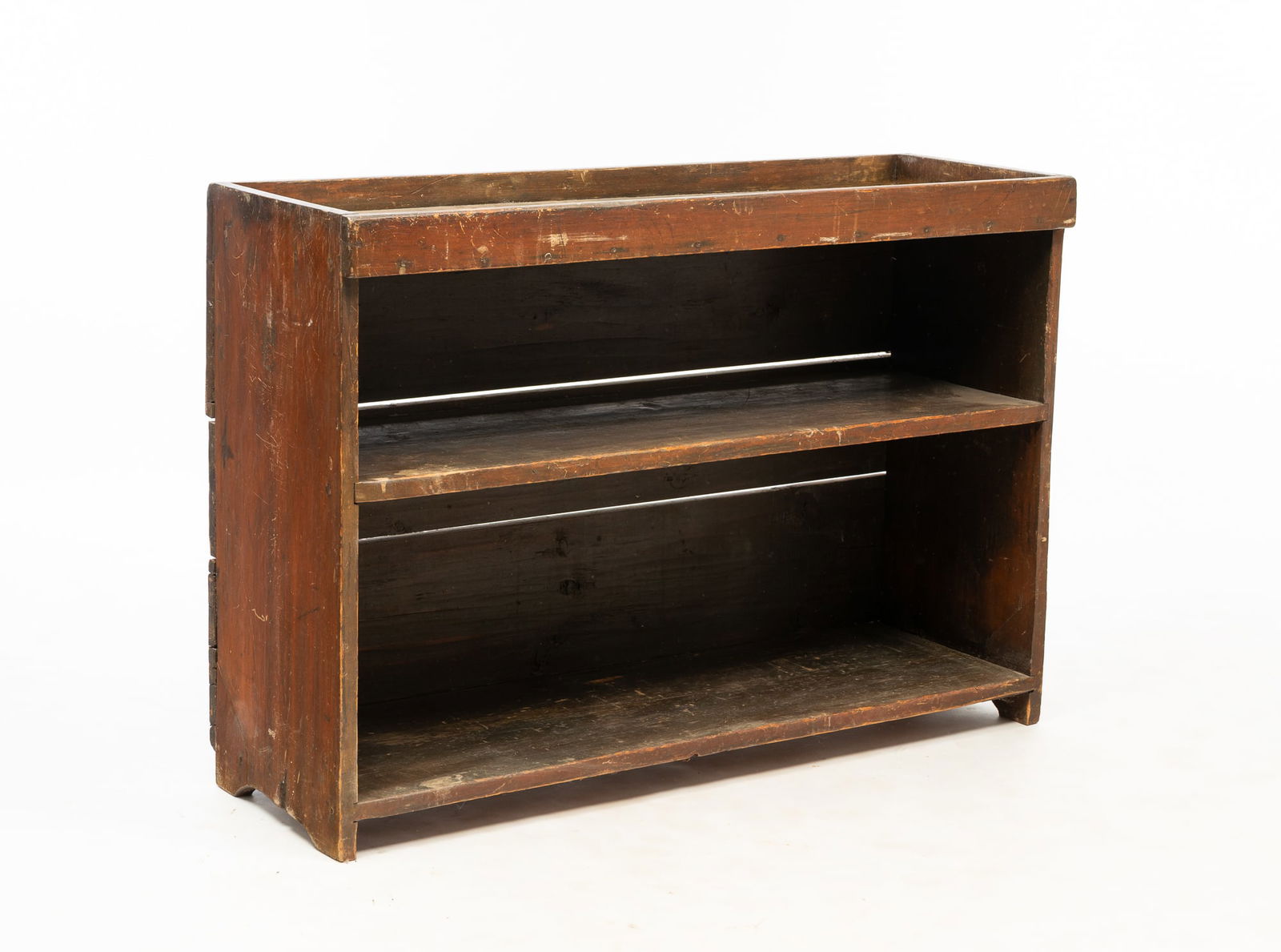 AMERICAN COUNTRY RED-WASHED PINE DRY SINK.: 19th Century. Having a long, shallow well over two shelves and ends with cut-out feet, peg construction with square cut nails.Provenance: From the Lifetime Collection of Darwin D. Bearley. 32"h. 46"w.
