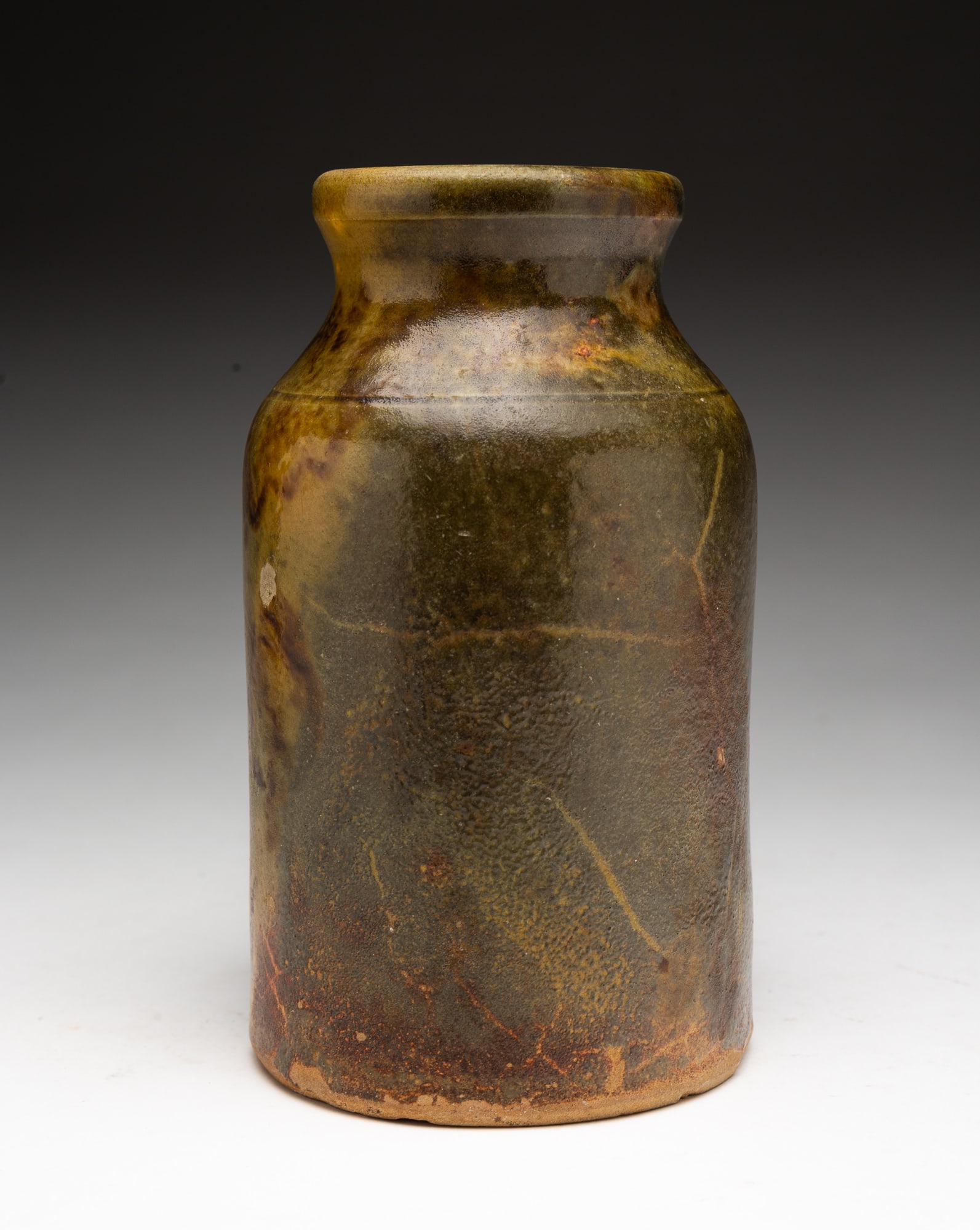 AMERICAN BUFF CLAY BOTTLE IN MOTTLED GLAZE. (1 of 3)